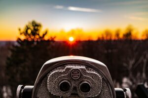 binoculars-focusing-on-sunset-in-nature