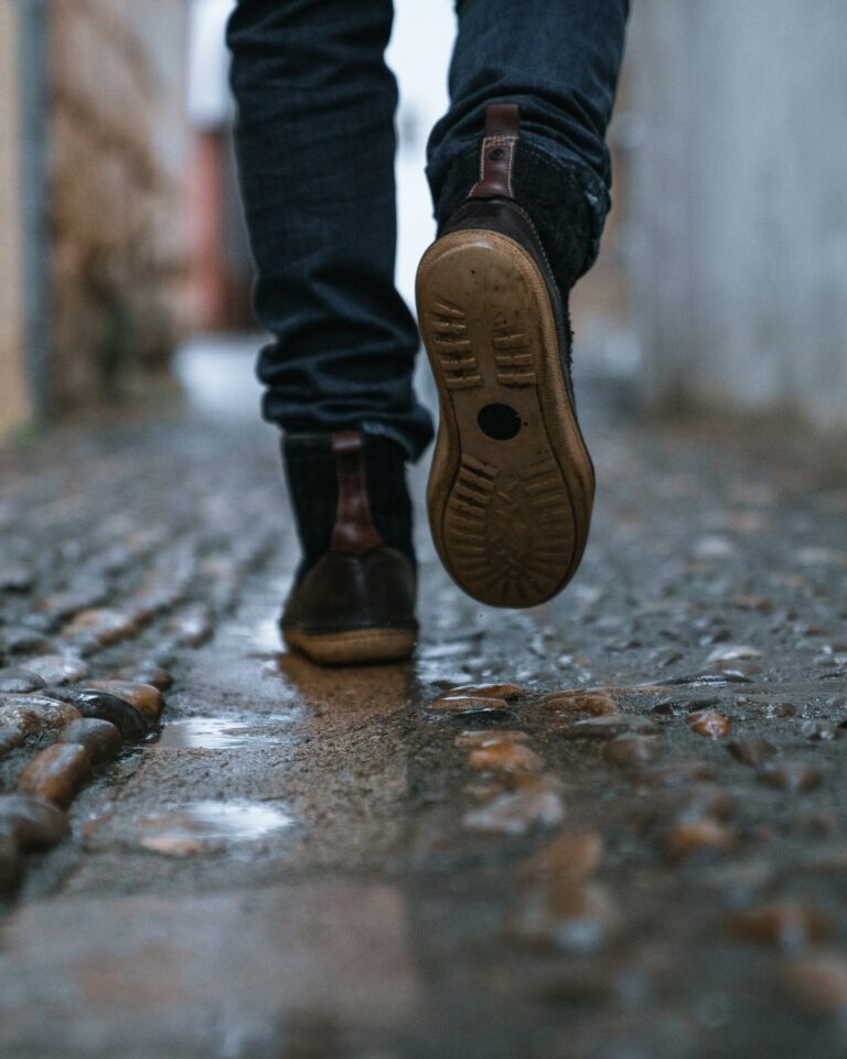 a mans feet taking steps on a street represent a walk with God