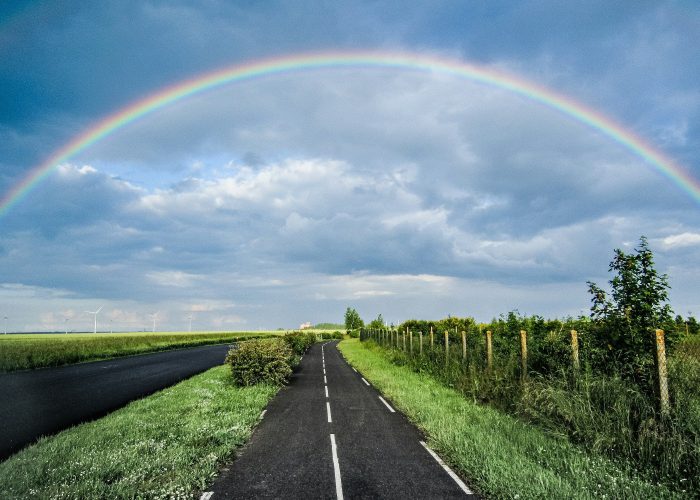 walking by the spirit rainbow path roadway path with rainbow